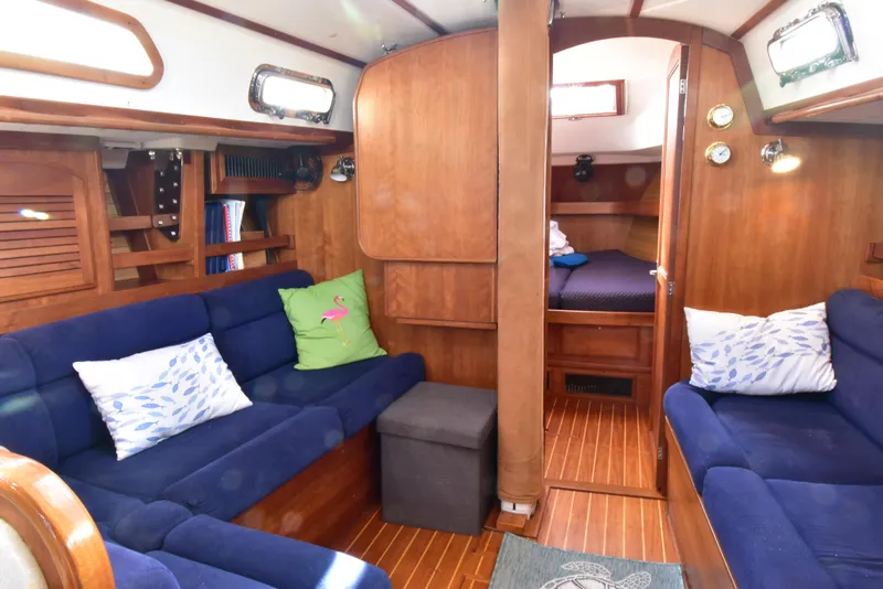Slide: The Image of Interior of 2004 Sabre 386 sailboat with blue seating and wooden finishes. - 10