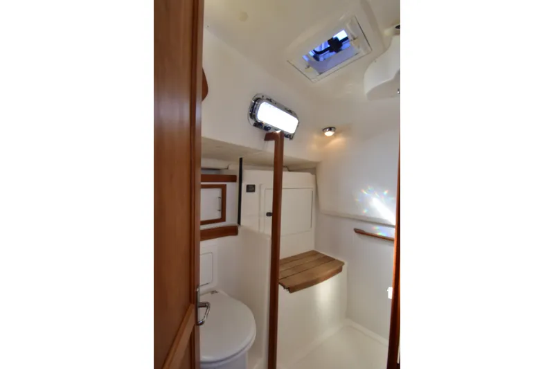 Slide: The Image of 2004 Sabre 386 yacht bathroom interior with wooden accents and overhead hatch. - 15