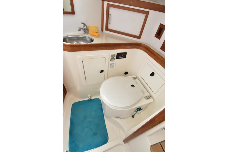Slide: The Image of Compact bathroom in 2004 Sabre 386 yacht with sink, toilet, and storage. - 17