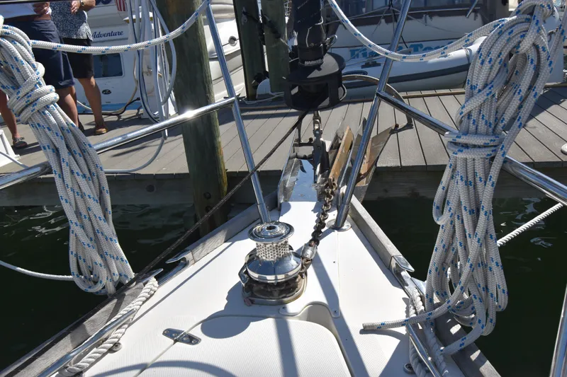 Slide: The Image of Bow of 2004 Sabre 386 sailboat docked, featuring coiled ropes and winch. - 2