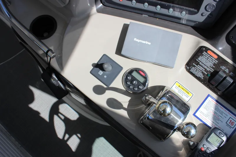Slide: The Image of Control panel of a 2006 Sea Ray 40 Sundancer with navigation equipment and throttle controls. - 12