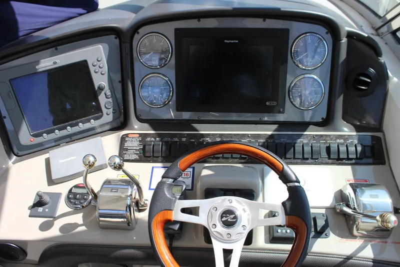 Slide: The Image of Dashboard of a 2006 Sea Ray 40 Sundancer boat with navigation controls. - 14