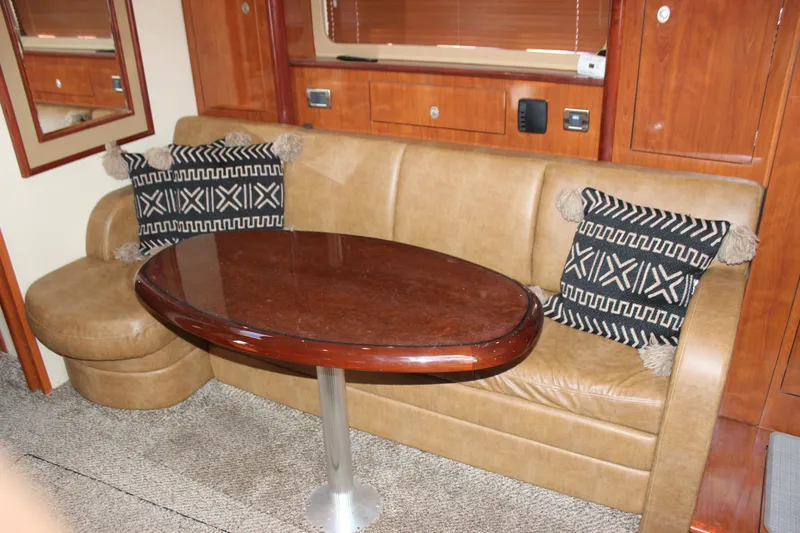 Slide: The Image of Luxurious interior of 2006 Sea Ray 40 Sundancer with leather seating and wooden table. - 23