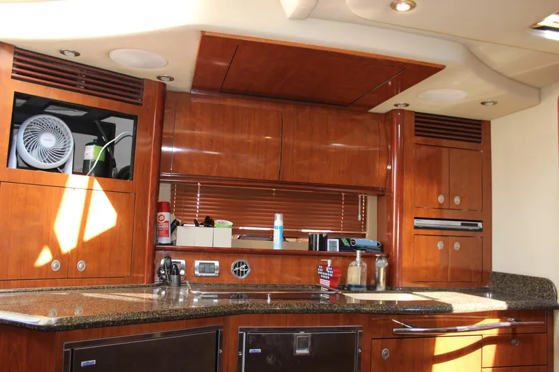 Slide: The Image of Luxurious 2006 Sea Ray 40 Sundancer yacht interior with wooden cabinetry and modern amenities. - 26