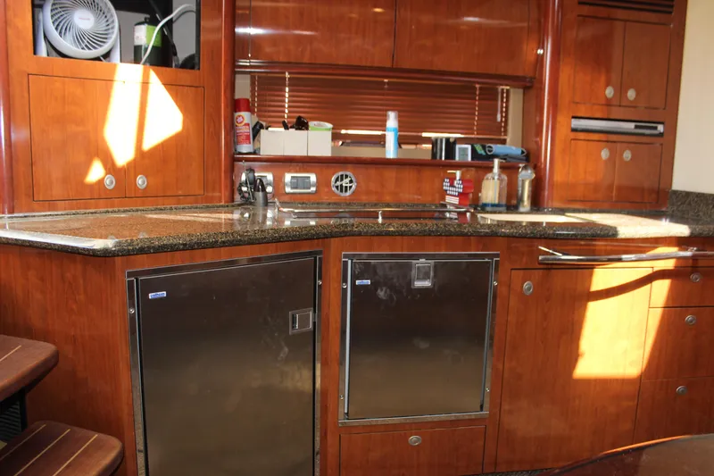 Slide: The Image of Luxurious 2006 Sea Ray 40 Sundancer yacht kitchen with wood cabinetry and stainless steel appliances. - 27