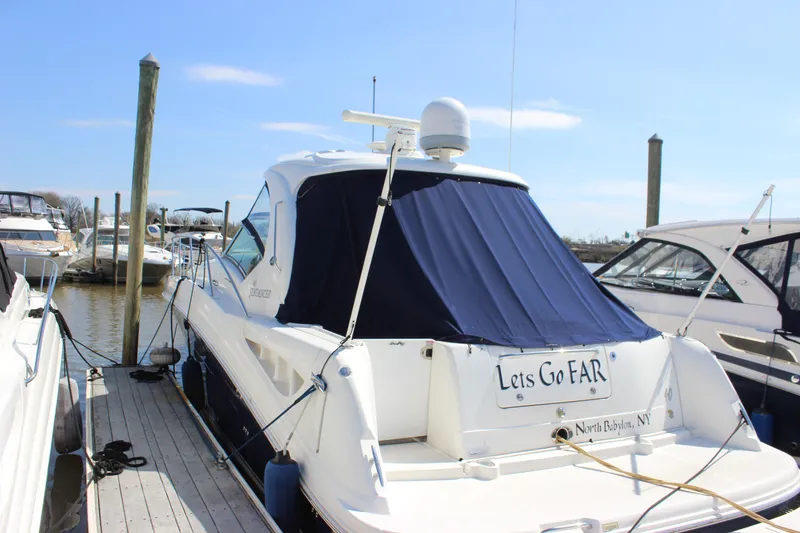 Slide: The Image of 2006 Sea Ray 40 Sundancer docked, featuring a blue cover and "Lets Go FAR" nameplate. - 3