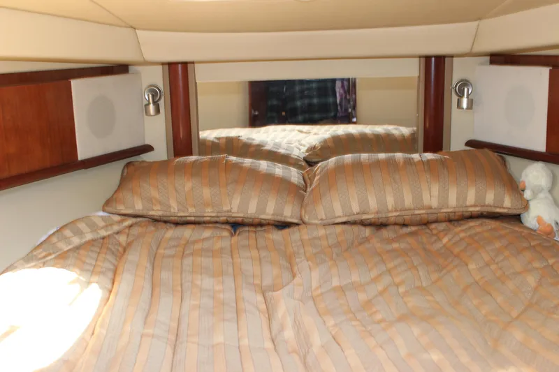 Slide: The Image of Interior cabin of 2006 Sea Ray 40 Sundancer with striped bedding and plush pillows. - 38