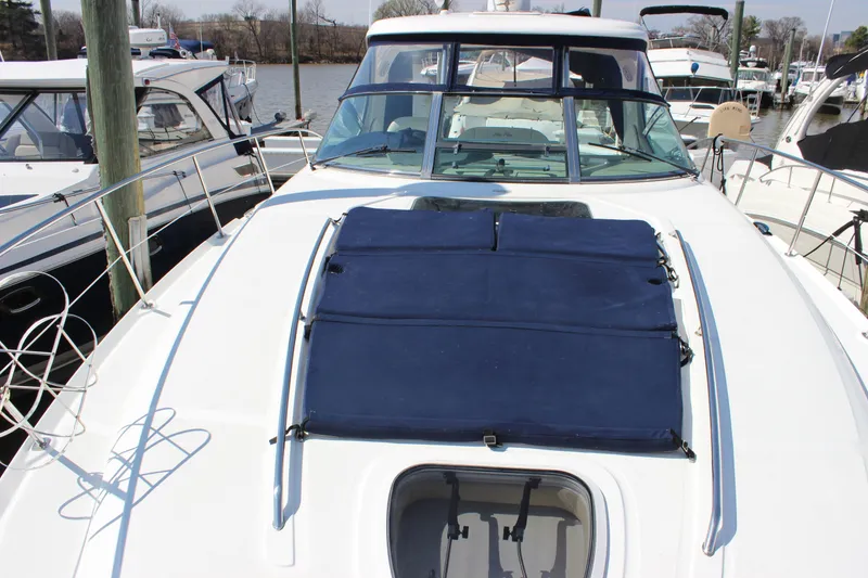 Slide: The Image of 2006 Sea Ray 40 Sundancer yacht with blue sunpad, docked at marina. - 43