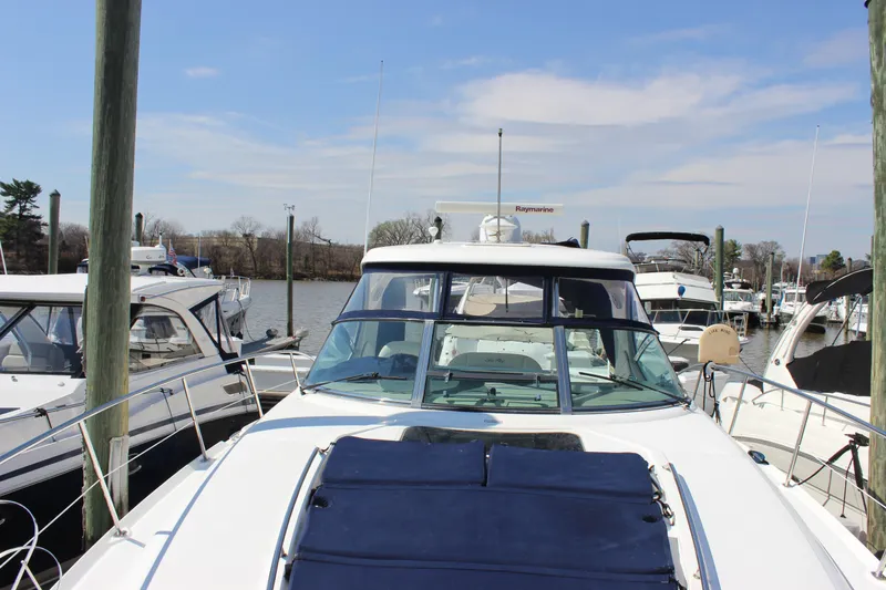 Slide: The Image of 2006 Sea Ray 40 Sundancer yacht docked at a marina under a clear blue sky. - 44