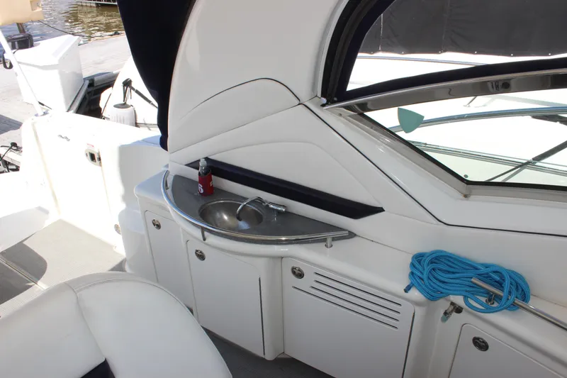 Slide: The Image of 2006 Sea Ray 40 Sundancer yacht interior with sink, storage, and blue rope. - 9