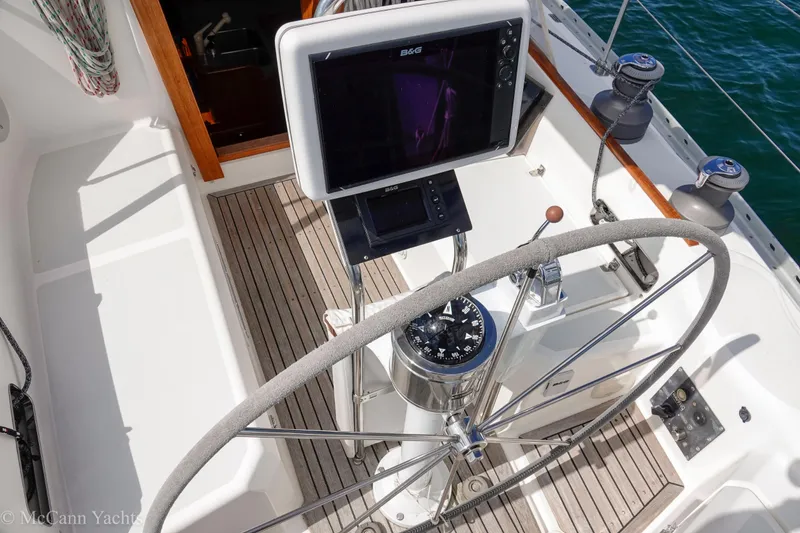 Slide: The Image of Cockpit of 1993 Alden 43 Aft, featuring steering wheel and navigation equipment. - 13