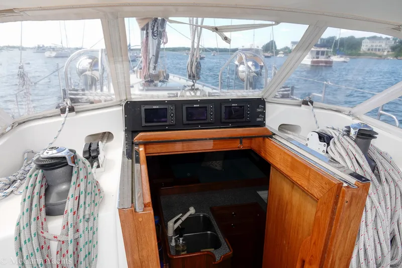 Slide: The Image of Alden 43 Aft Cockpit sailboat interior, showcasing navigation equipment and cabin entrance, 1993 model. - 25