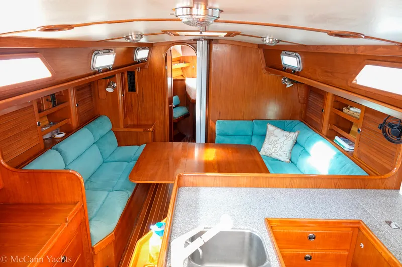 Slide: The Image of Luxurious 1993 Alden 43 Aft Cockpit yacht interior with wooden finish and teal seating. - 29