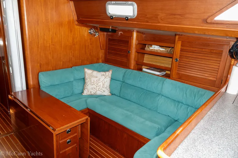 Slide: The Image of Cozy interior of 1993 Alden 43 Aft Cockpit yacht with teal seating and wooden finish. - 30