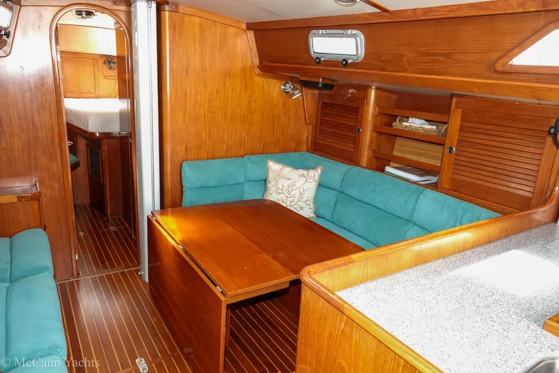 Slide: The Image of Interior of 1993 Alden 43 Aft Cockpit yacht with wooden finish and teal seating. - 31