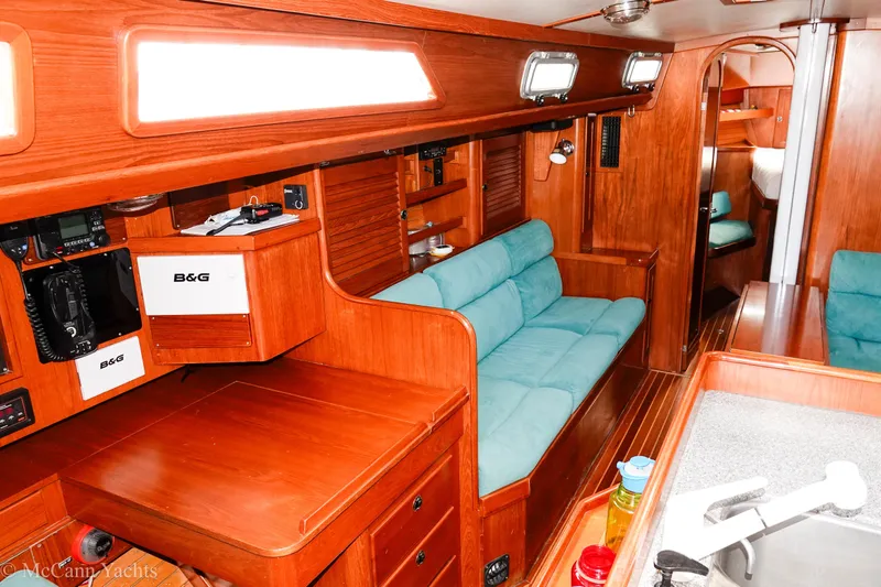 Slide: The Image of Interior of 1993 Alden 43 Aft Cockpit yacht with wooden finish and teal seating. - 33