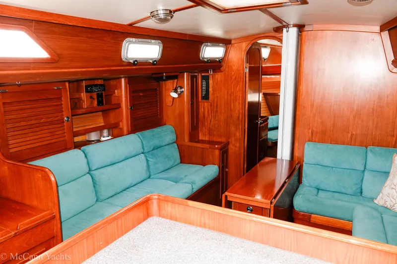 Slide: The Image of Interior of 1993 Alden 43 Aft Cockpit yacht with teal seating and wooden finishes. - 38