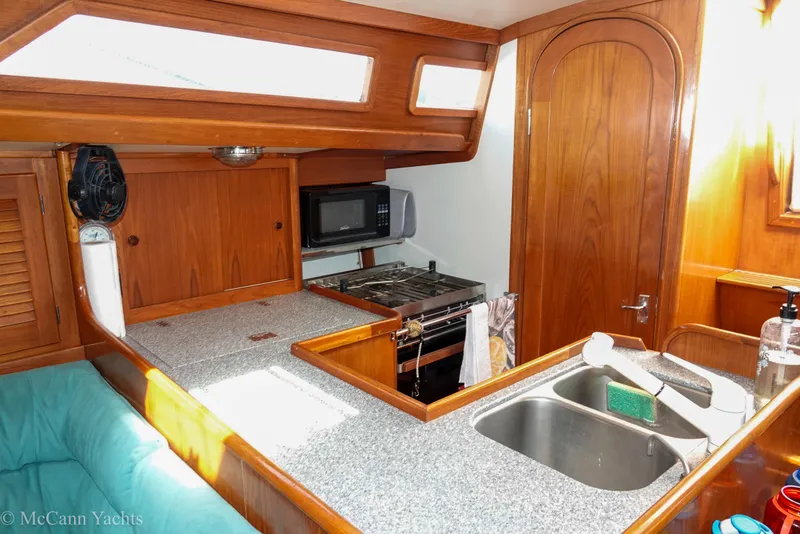 Slide: The Image of Interior of 1993 Alden 43 Aft Cockpit yacht with kitchen and wooden cabinetry. - 39