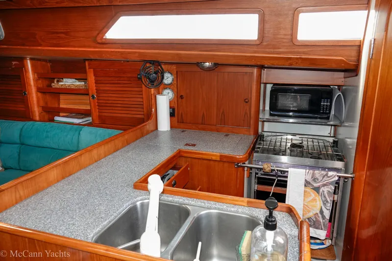 Slide: The Image of Interior of 1993 Alden 43 Aft Cockpit yacht featuring a compact kitchen area. - 41