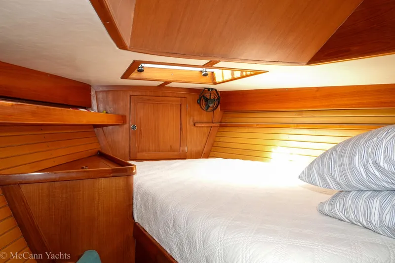 Slide: The Image of Cozy cabin interior of 1993 Alden 43 Aft Cockpit yacht with wooden paneling and bedding. - 46