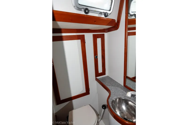 Slide: The Image of Bathroom interior of 1993 Alden 43 Aft Cockpit yacht with wood accents and stainless steel sink. - 47