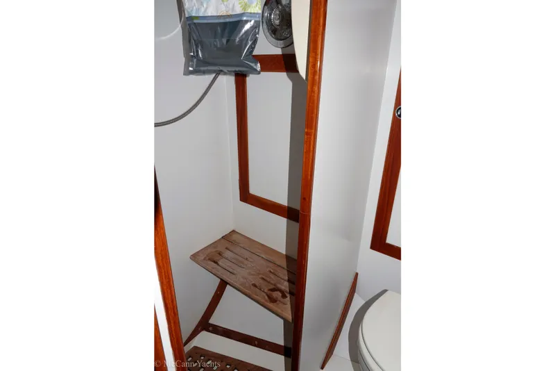 Slide: The Image of Interior of 1993 Alden 43 Aft Cockpit yacht bathroom with wooden accents. - 48