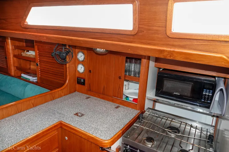 Slide: The Image of Cozy galley in 1993 Alden 43 Aft Cockpit yacht with stove and microwave. - 51