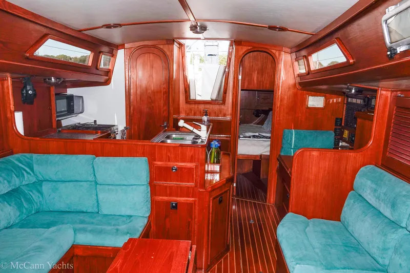 Slide: The Image of Interior of 1993 Alden 43 Aft Cockpit yacht with wood finish and teal seating. - 54