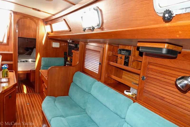 Slide: The Image of Interior of 1993 Alden 43 Aft Cockpit yacht with wooden finish and teal seating. - 55
