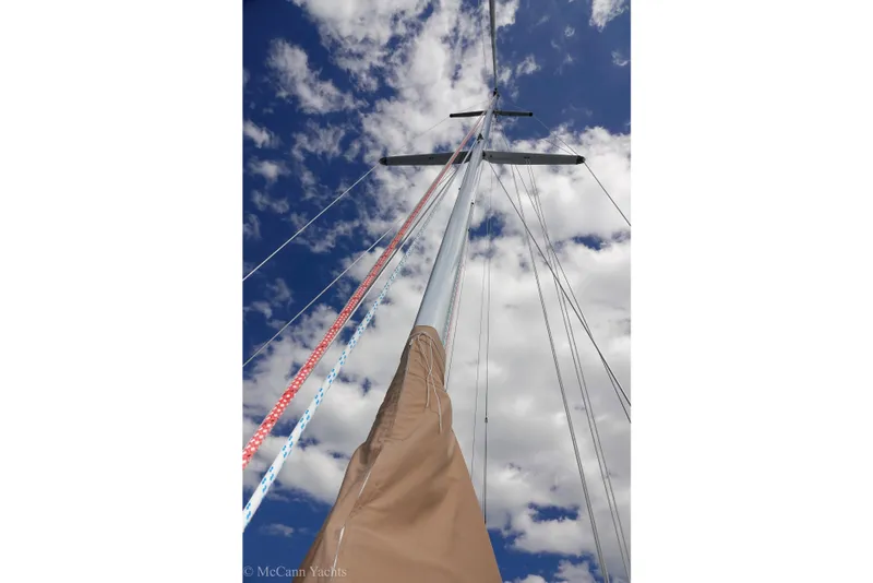 Slide: The Image of Sailboat mast and rigging against a cloudy blue sky, Alden 43 Aft Cockpit, 1993. - 62