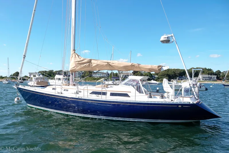 Slide: The Image of Alden 43 Aft Cockpit sailboat, 1993 model, anchored in a scenic harbor. - 8