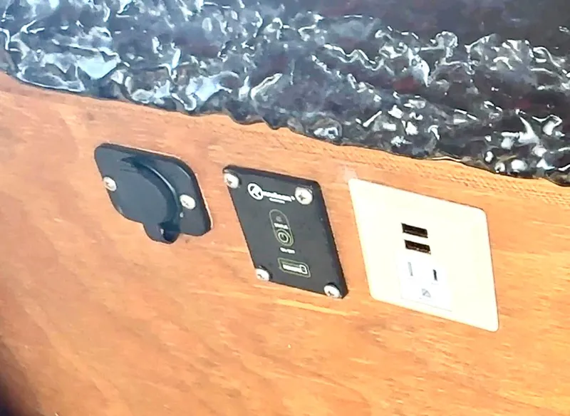 Slide: The Image of USB and power outlets on 2023 Beachcat 23 Catamaran interior panel. - 13