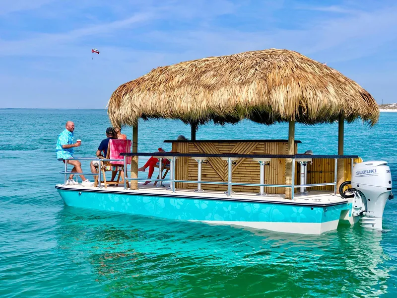 Slide: The Image of 2023 Beachcat 23 Catamaran with tiki hut, cruising on turquoise waters. - 4