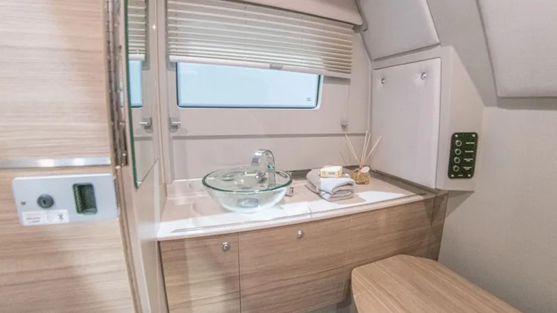 Slide: The Image of Interior of 2025 Saxdor 320 GTC, featuring modern bathroom with glass sink and wooden cabinetry. - 11