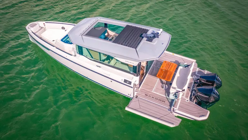 Slide: The Image of 2025 Saxdor 320 GTC boat on green water, aerial view. - 3