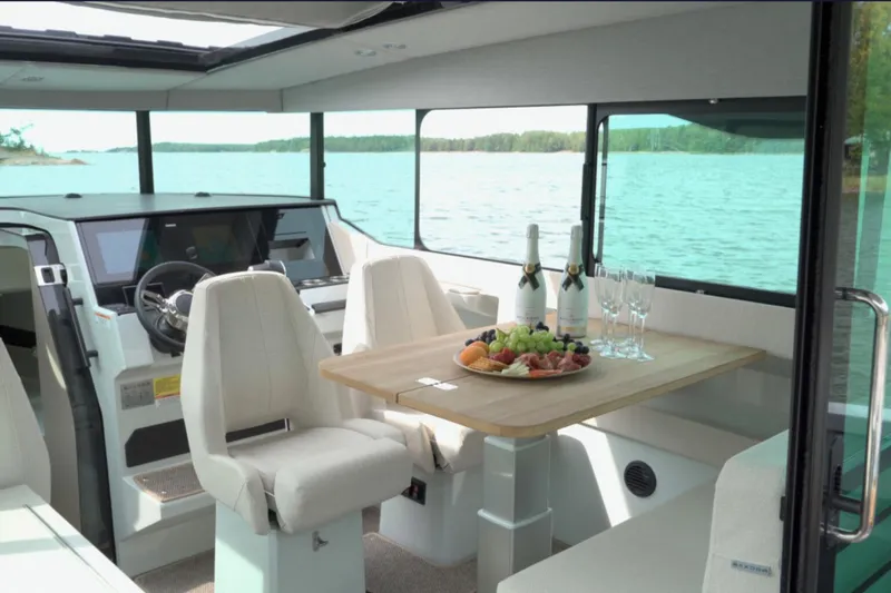 Slide: The Image of 2025 Saxdor 320 GTC interior with dining setup, featuring lake view and modern design. - 8