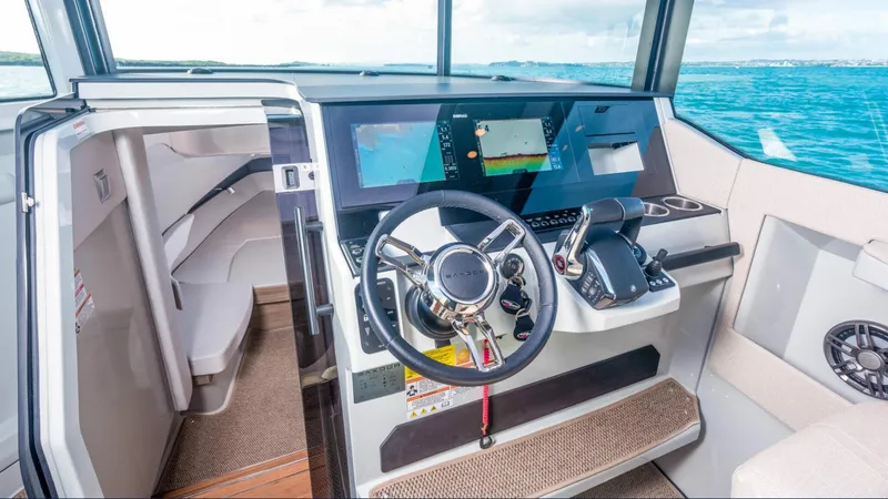 Slide: The Image of 2025 Saxdor 320 GTC helm with modern controls and navigation screens, overlooking the ocean. - 9