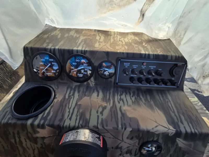 Slide: The Image of Dashboard of 2026 Crestliner 1860 Retriever SC with gauges and switches. - 10