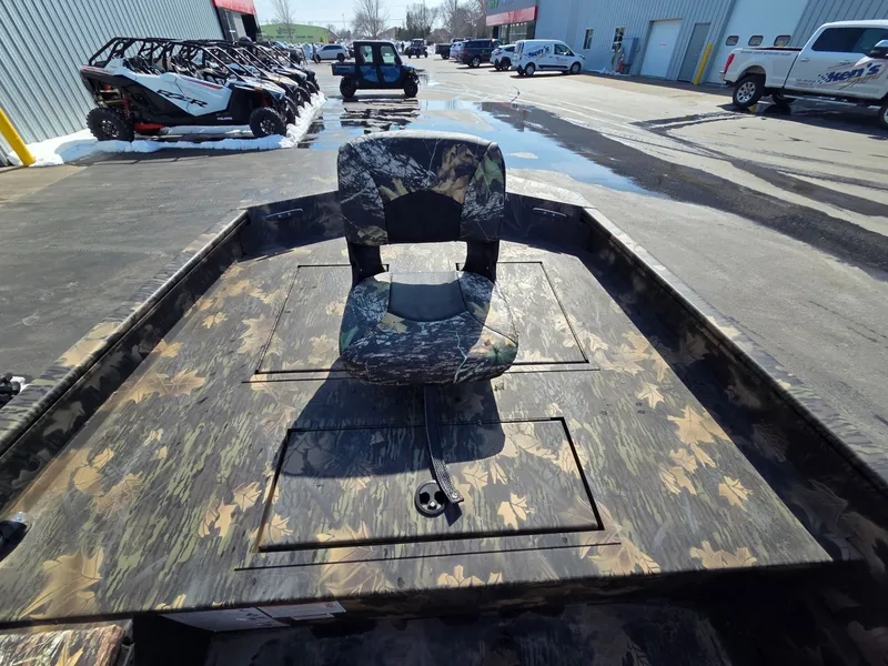 Slide: The Image of 2026 Crestliner 1860 Retriever SC with camouflage pattern and seat outdoors. - 13