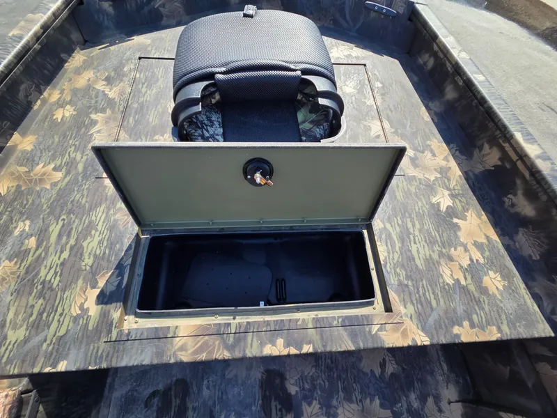 Slide: The Image of 2026 Crestliner 1860 Retriever SC with open storage compartment and camouflage design. - 14