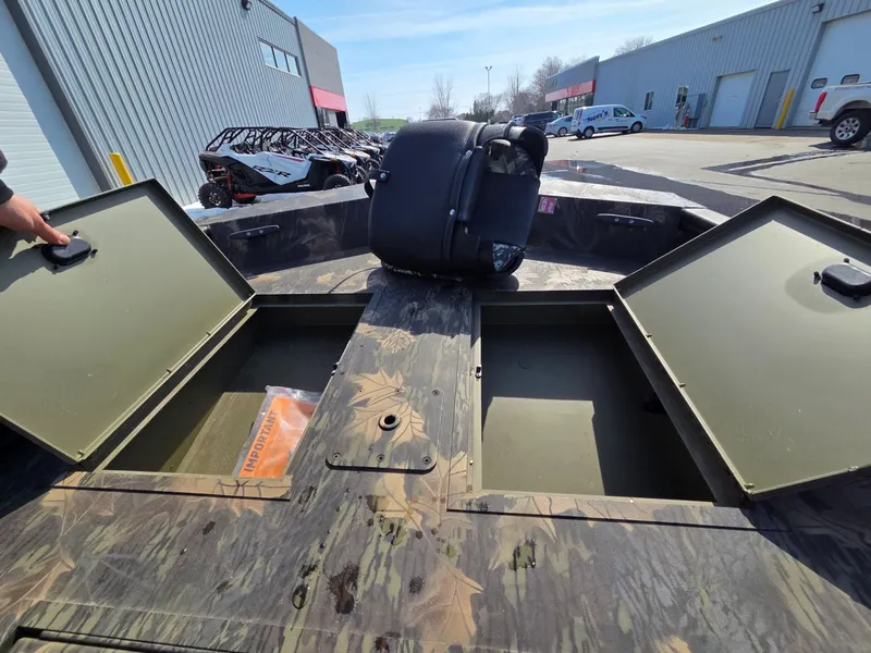 Slide: The Image of 2026 Crestliner 1860 Retriever SC with storage compartments and camouflage design. - 15