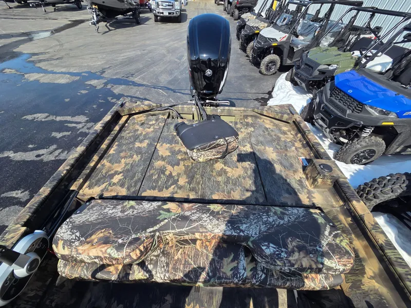 Slide: The Image of 2026 Crestliner 1860 Retriever SC with camouflage pattern and outboard motor. - 7