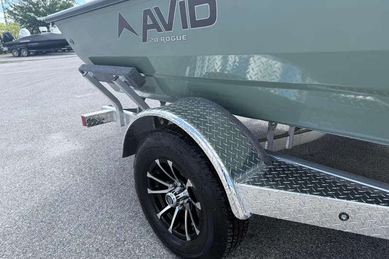 Slide: The Image of Avid 20 Rogue CC 2026 boat on a trailer with diamond plate fender. - 1