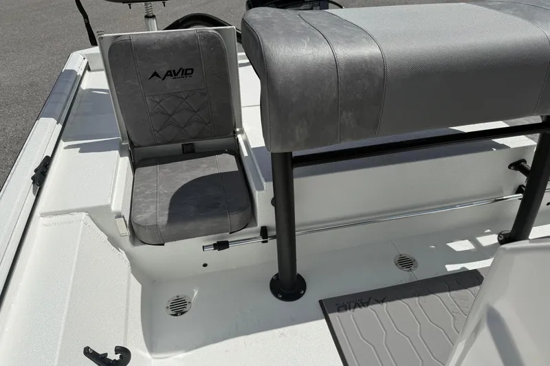 Slide: The Image of 2026 Avid 20 Rogue CC boat interior with gray seating and Avid logo. - 11