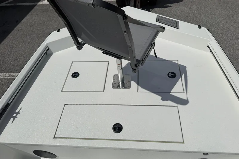 Slide: The Image of 2026 Avid 20 Rogue CC boat deck with a mounted chair and storage compartments. - 19