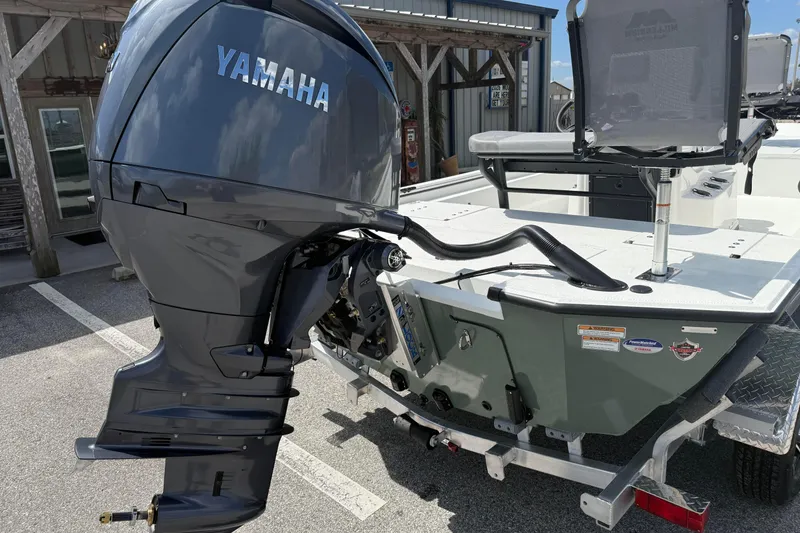 Slide: The Image of Avid 20 Rogue CC 2026 boat with Yamaha outboard motor in a parking area. - 3
