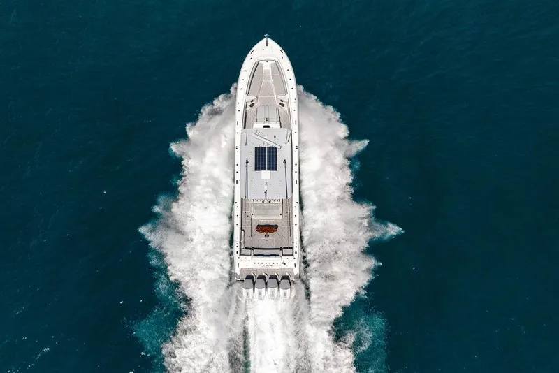 Slide: The Image of Aerial view of 2023 HCB 53 Suenos boat cruising on open water. - 14