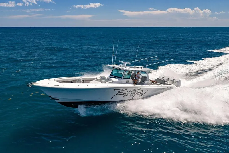 Slide: The Image of 2023 HCB 53 Suenos boat cruising on open ocean under clear blue sky. - 2