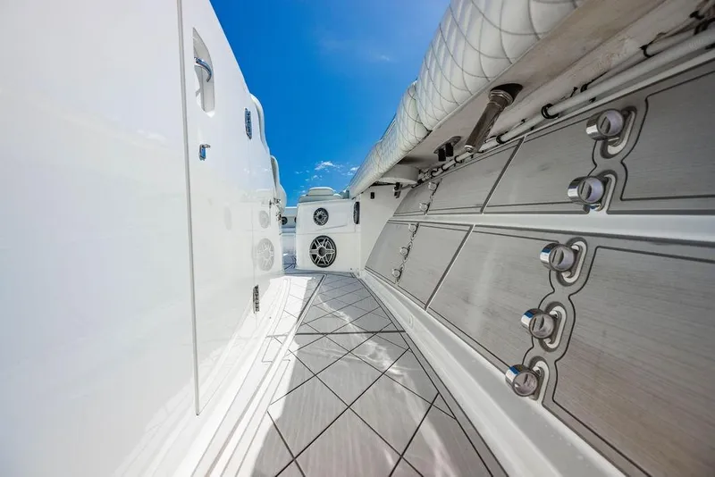 Slide: The Image of 2023 HCB 53 Suenos yacht deck with sleek design and modern features under a clear blue sky. - 22