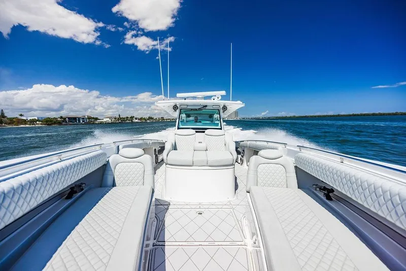 Slide: The Image of 2023 HCB 53 Suenos luxury boat cruising on a sunny day, showcasing elegant seating. - 23